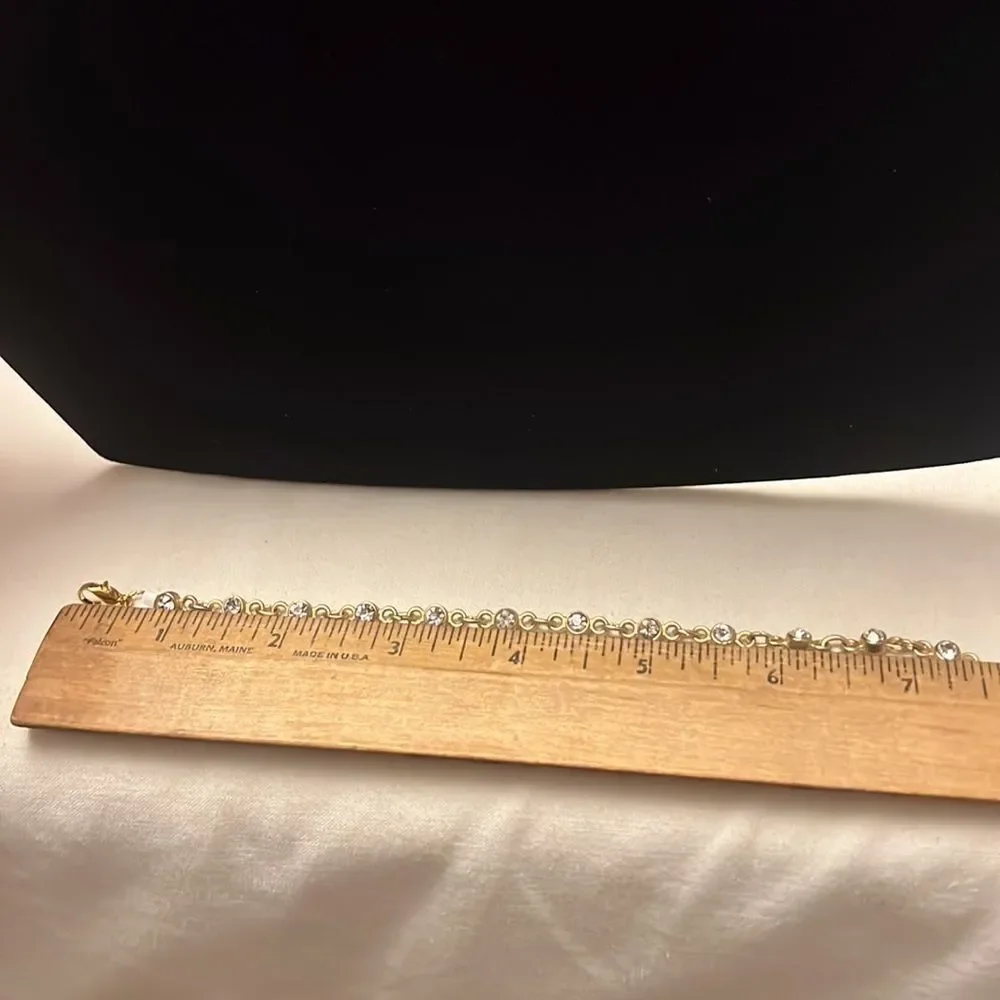 Handcrafted gold tone bracelet with clear stone detail